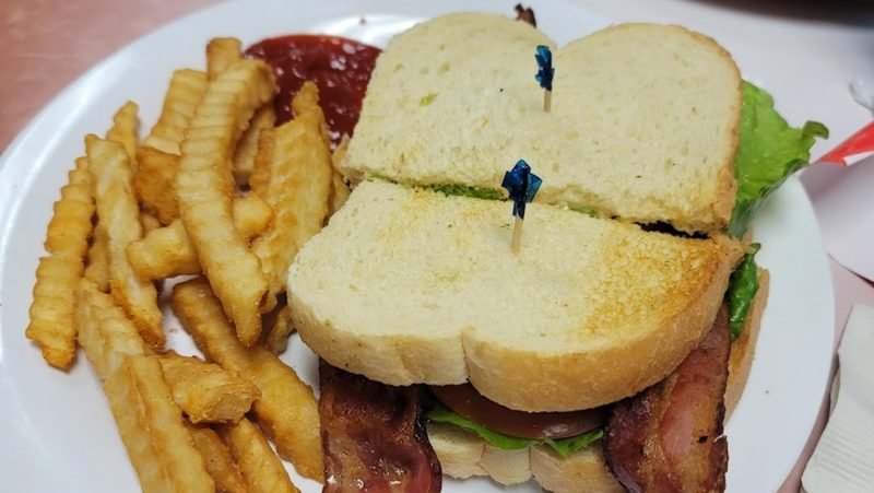 Bacon lettuce and tomato sandwich on sourdough with fries