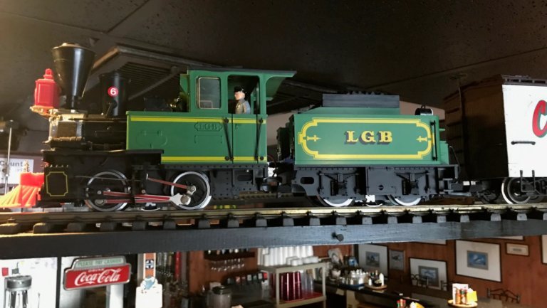 Miniature LGB steam locomotive running on the shelf railway