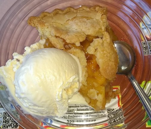Deep-dish pie with a scoop of vanilla ice cream